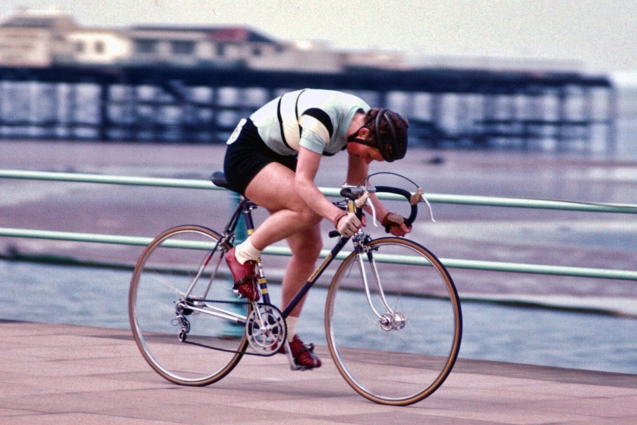 Beryl Burton with her head down riding in a seafront crit.