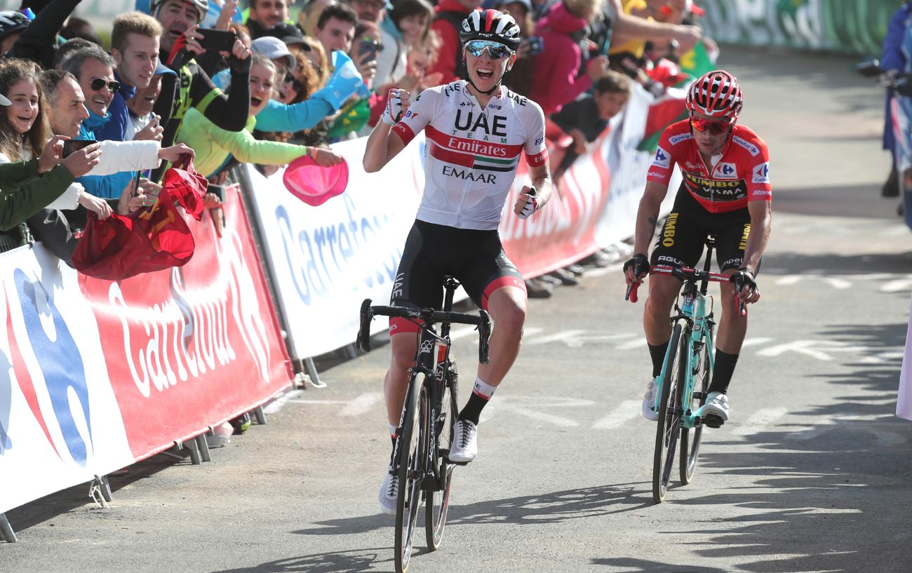 Tadej Pogacar pumps his fist in celebration after beating Primoz Roglic at the 2019 Vuelta.