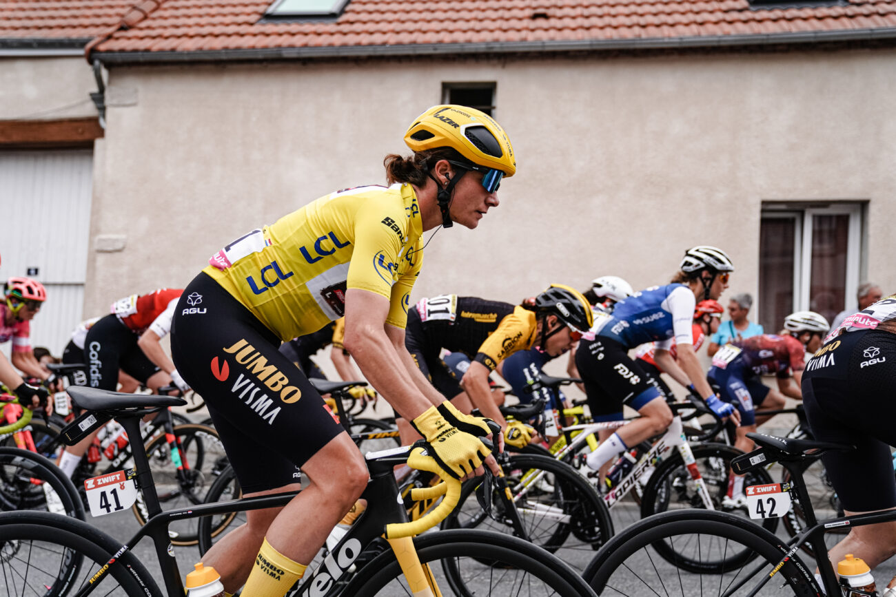 Marianne Vos riding for Jumbo-Visma in the yellow jersey in the Tour de France Femmes, riding a Cervelo road bike with yellow grip tape.