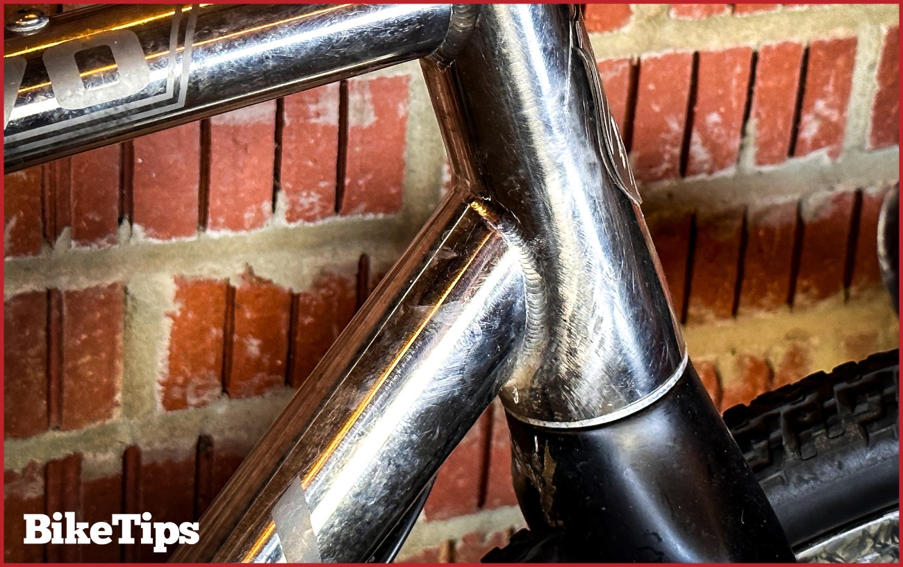 A headtube of a titanium bike.