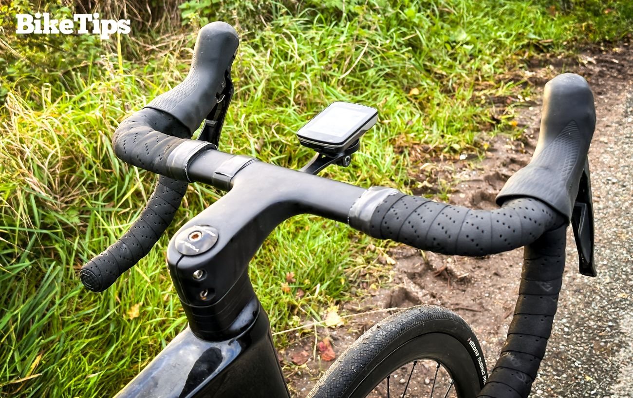 Road bike handlebars with a head unit displaying information from the cycling power meter.