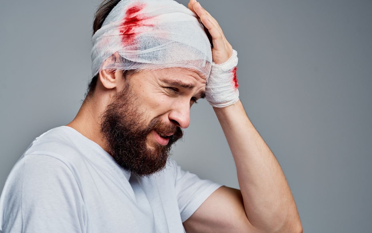A man wearing a bandage around his head with a head injury.