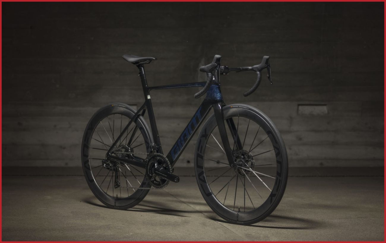 A Giant Propel Advanced SL 0 sits in a concrete warehouse.