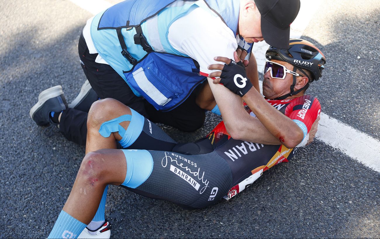Santiago Buitrago lies on the tarmac in pain after crashing on Stage 4 of the 2023 Vuelta a Espana.