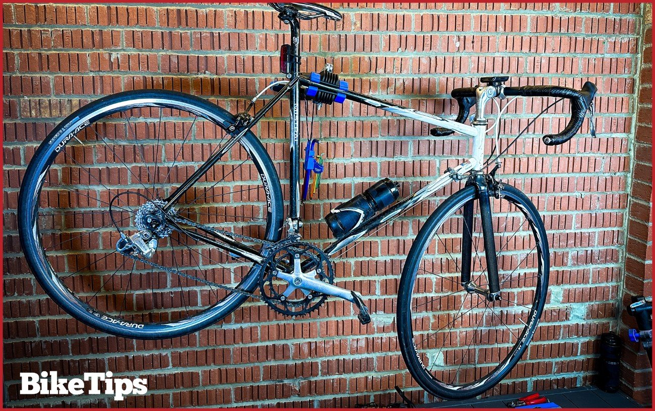 A classic road bike on a wall stand. 