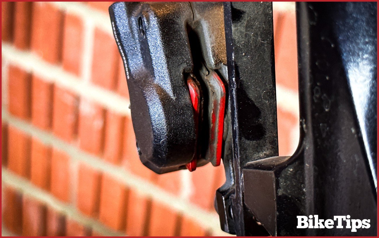 A close up picture of a disc brake caliper without a disc in.