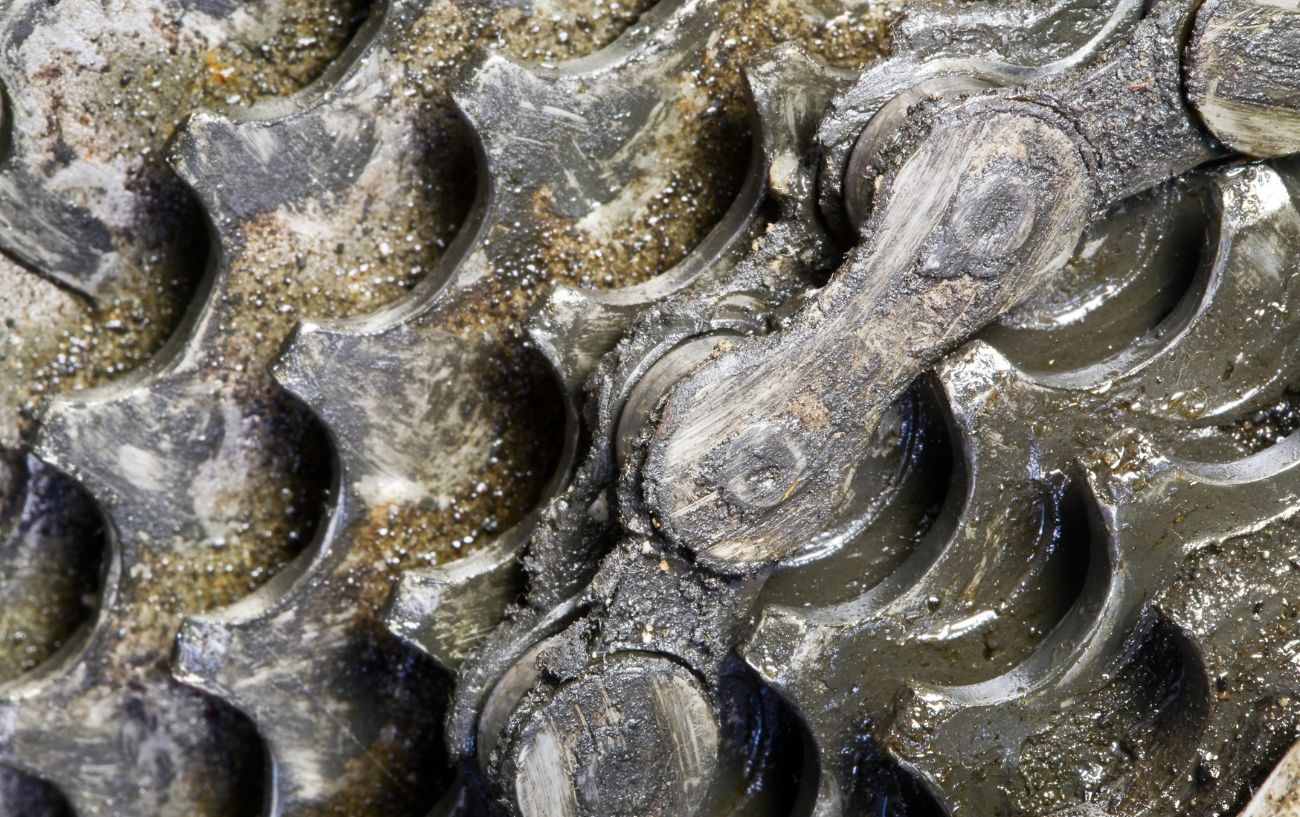 A dirty bike cassette, covered in grease and mud.