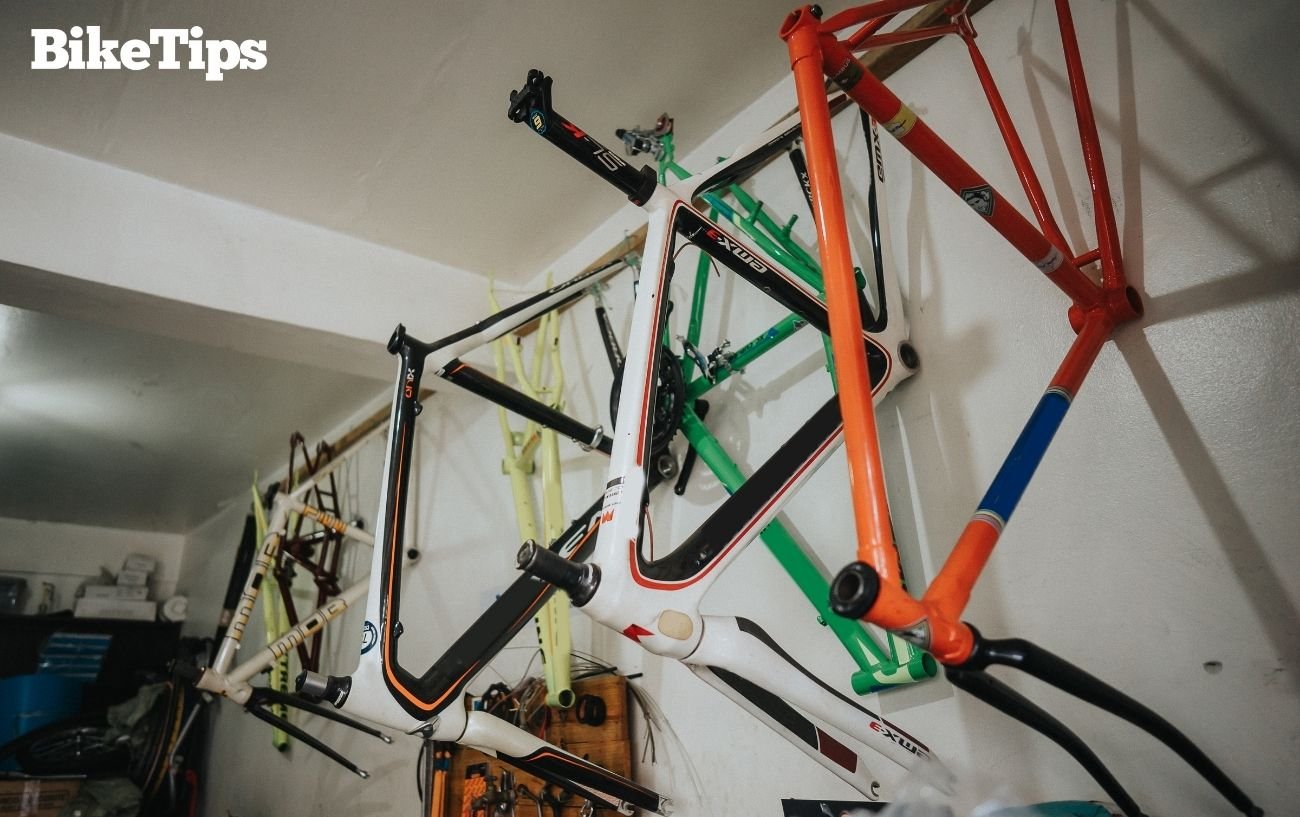 Row of winter bike frames of different materials.