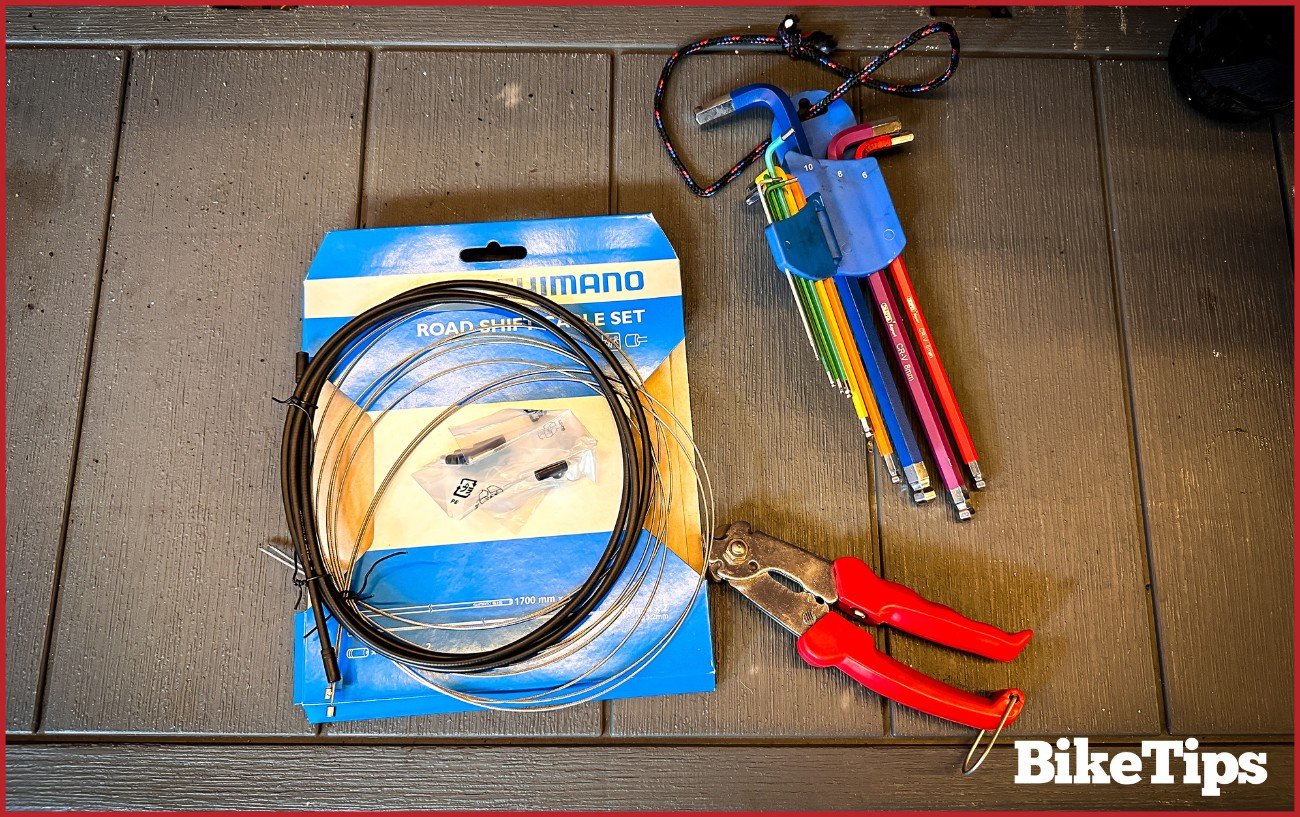 A bike shift cable kit, Allen keys, and bike cable cutters.