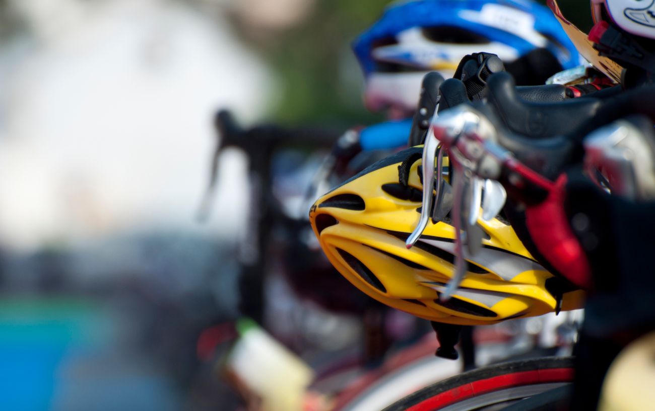 Close-up of a row of bikes and helmets in the transition area of a sprint triathlon distance.