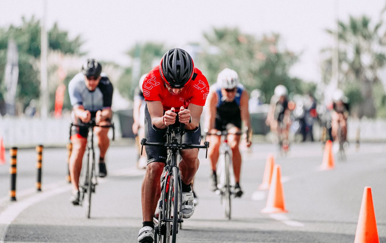 A group of triathletes during the cycling leg of a Half Ironman triathlon distance.