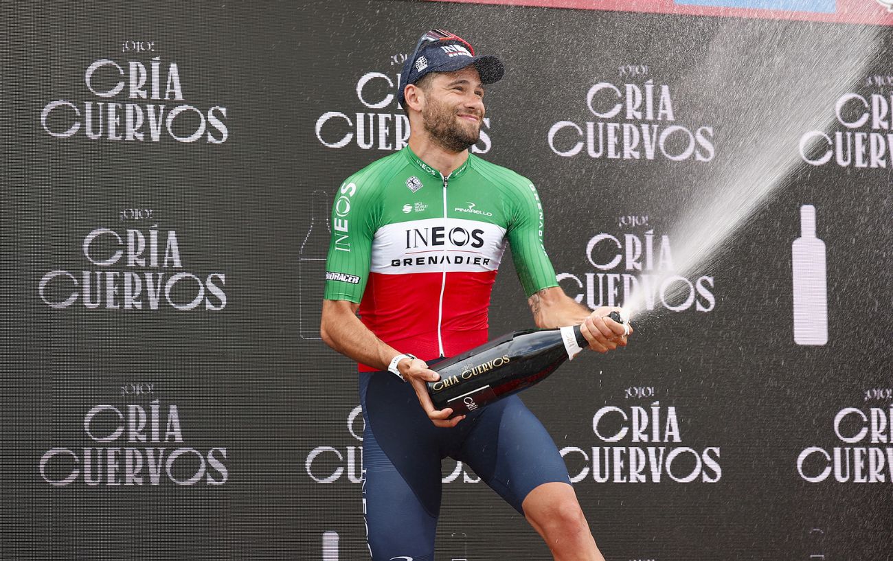 Filippo Ganna celebrates winning Stage 10 of the 2023 Vuelta by popping a champagne bottle.