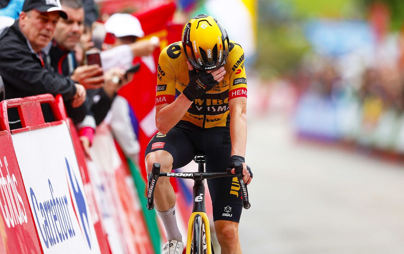 Jonas Vingegaard covers his face with his hand as he crosses the line on Stage 16 of the 2023 Vuelta a Espana.