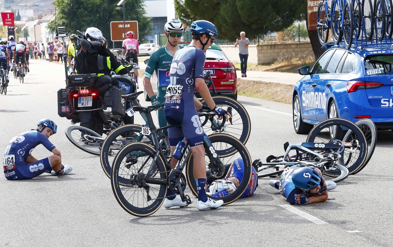 Kaden Groves stands with other riders still on the floor after a crash on Stage 19 of the 2023 Vuelta a Espana.