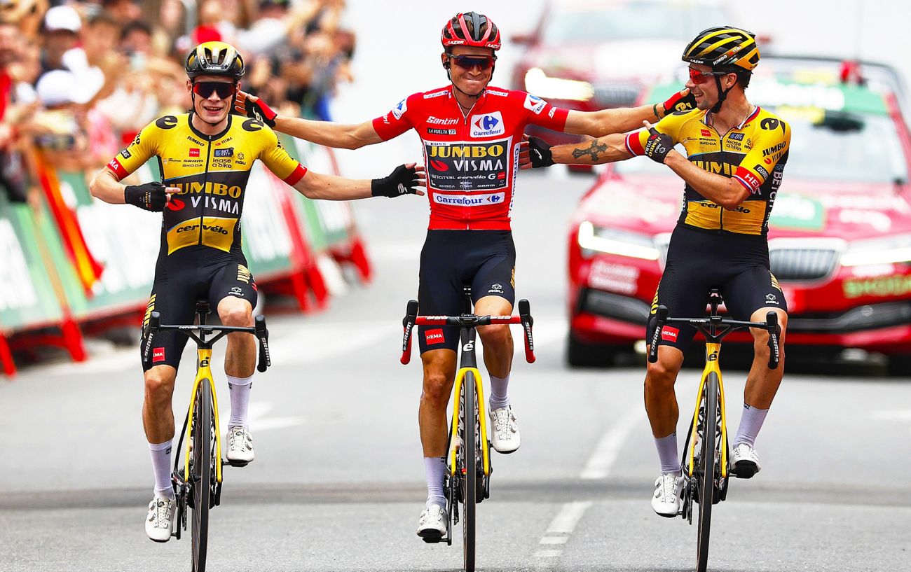 Sepp Kuss, Primoz Roglic, and Jonas Vingegaard cross the finish line arm-in-arm on Stage 20 of the 2023 Vuelta a Espana.