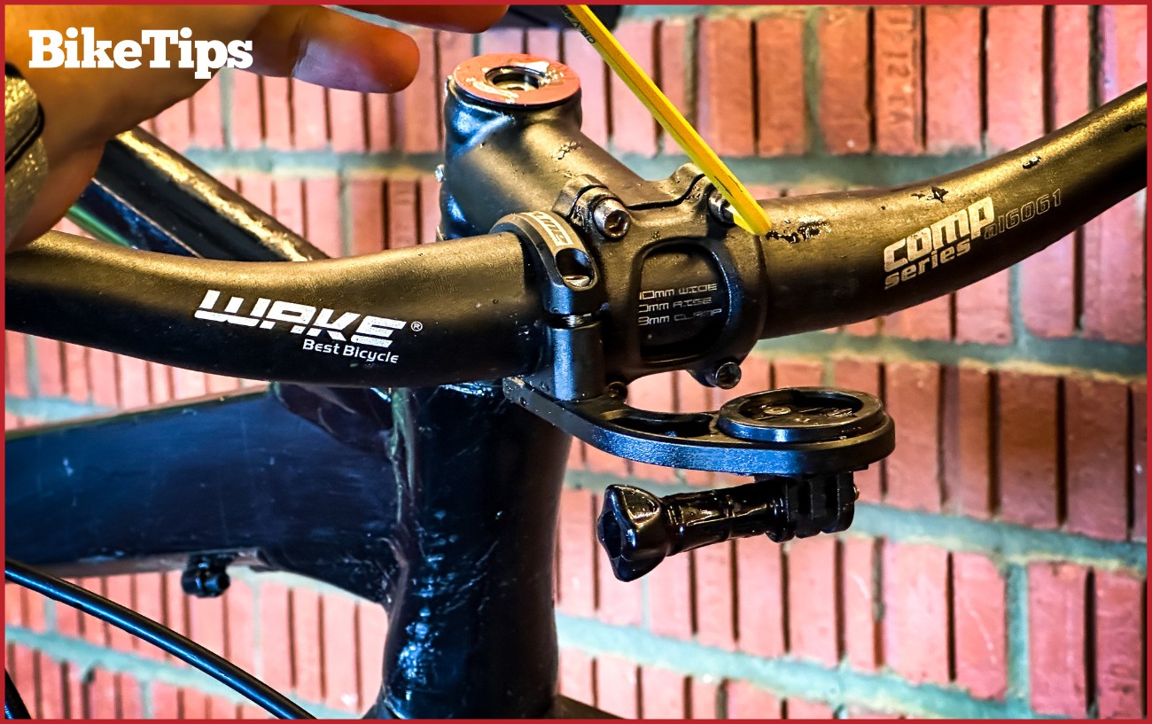 An Allen key tightening a bikes stem front plate.