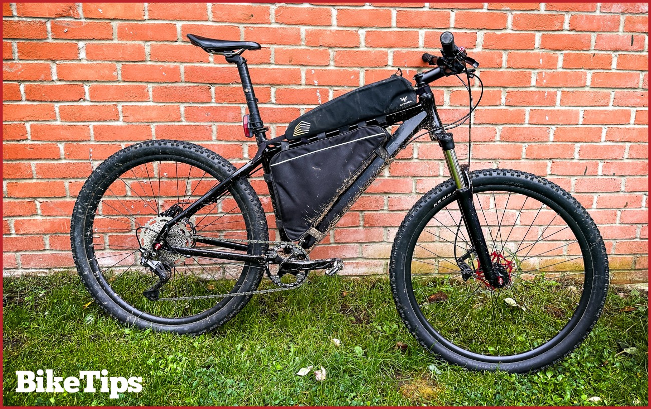 A mountain bike against a brick wall.