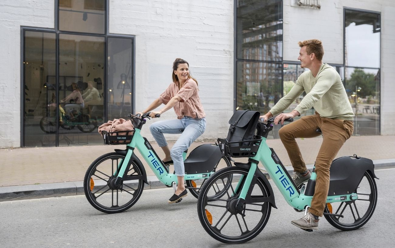 Press image of a couple riding TIER electric bikes.
