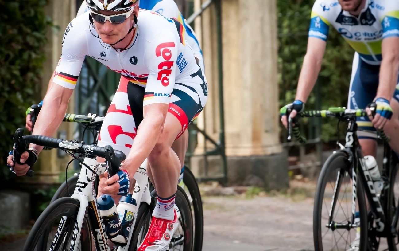 André Greipel rides a white road bike with a slammed stem.
