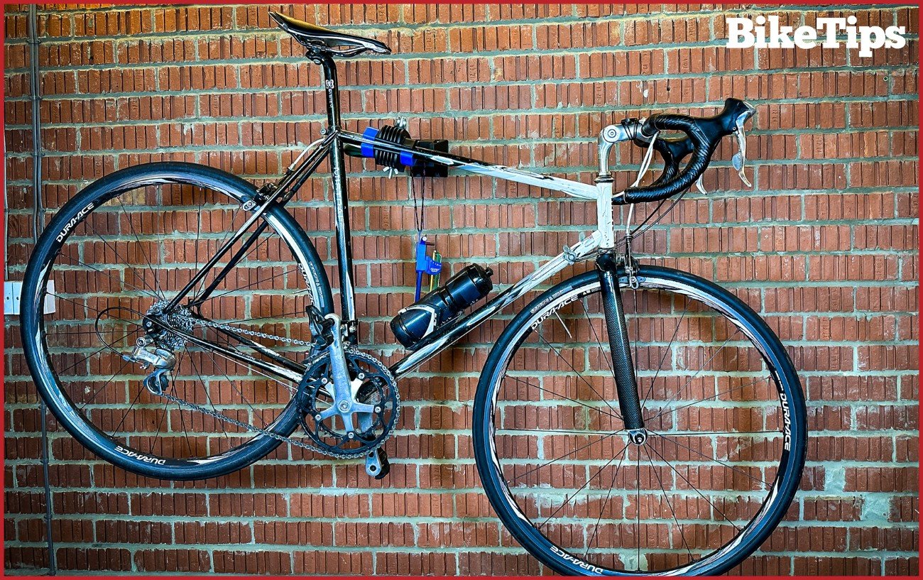 A road bike with rim brakes in a stand.