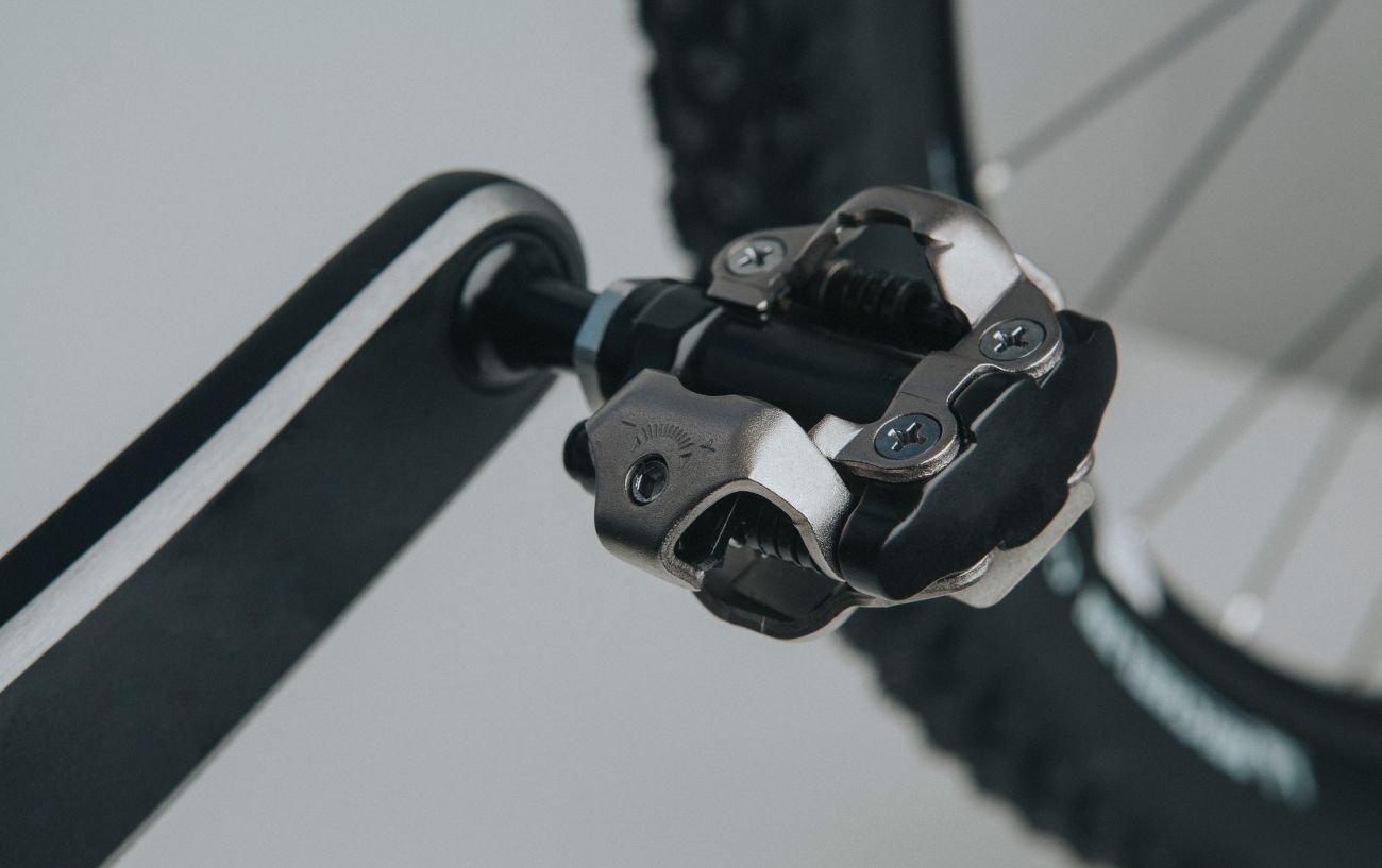 Close-up of Shimano SPD-SL pedals on a grey background.