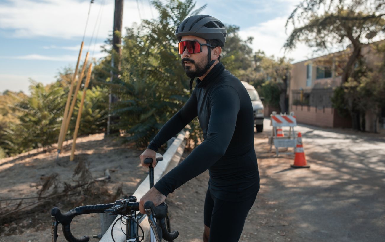 A cyclist pauses on his bike after suffering from saddle sores.