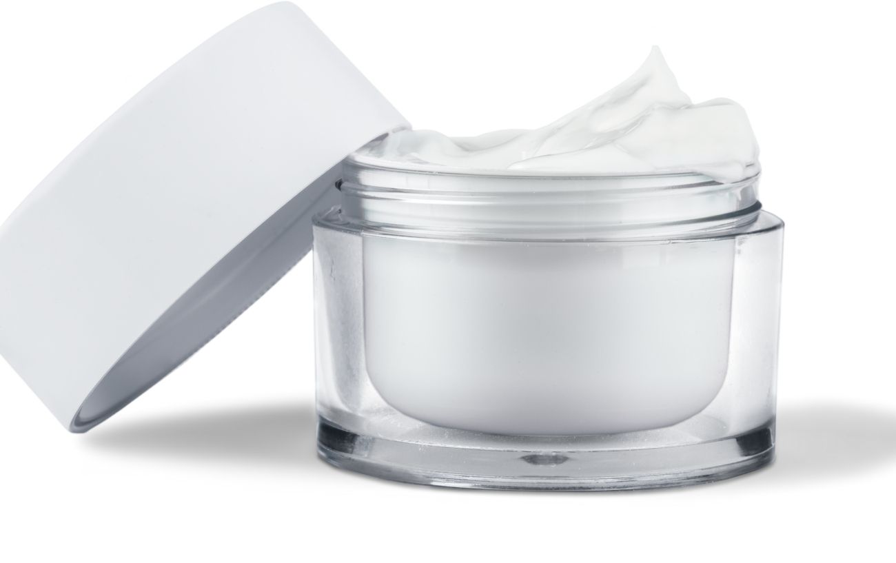 A pot of white cream with a white background.