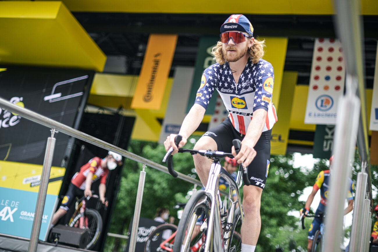 Quinn Simmons prepares for a stage of the 2023 Tour de France while wearing the American national champion's jersey.