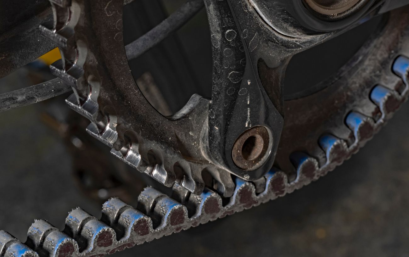 A black and grey belt drive system on a motorbike.