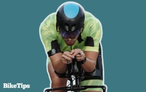 Graphic showing a triathlete riding a bike on a green background.