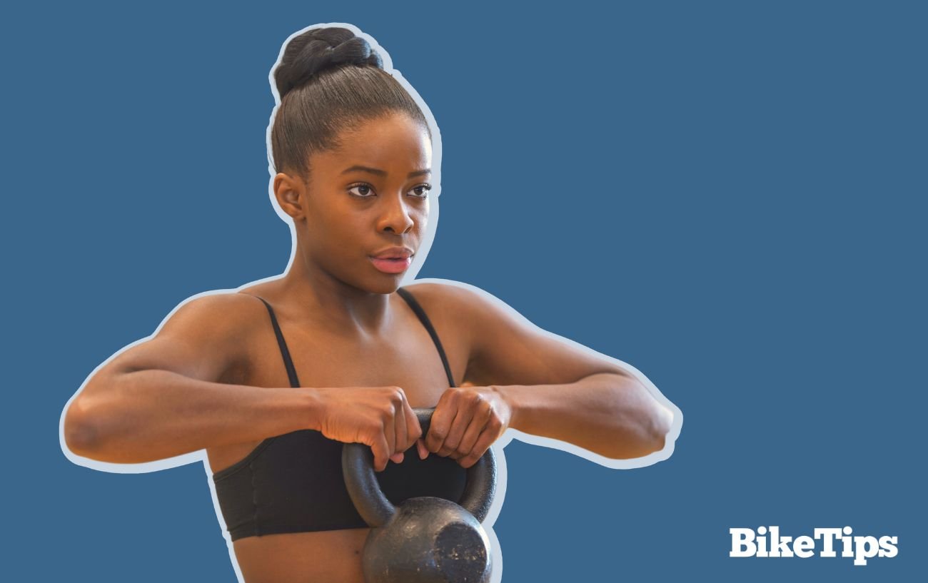 A cyclist lifts weights to ensure she gets a full-body workout covering the muscles that are not worked by cycling.