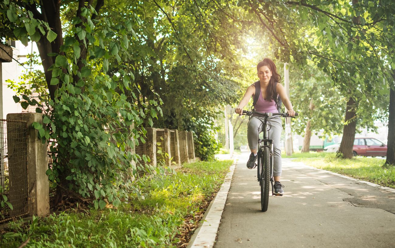 A cyclist rides along a bike path in an American city.