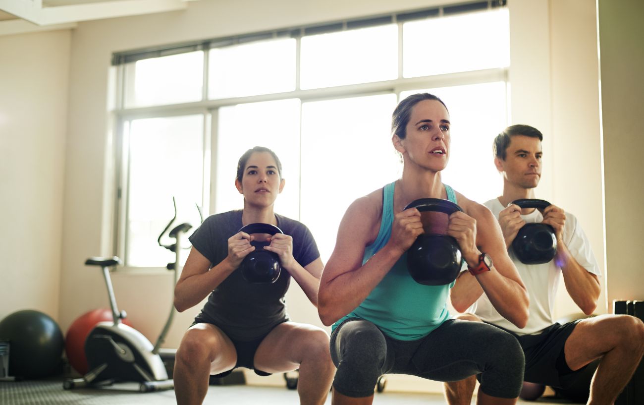 A group of cyclists engage in strength training to prevent muscle imbalances.
