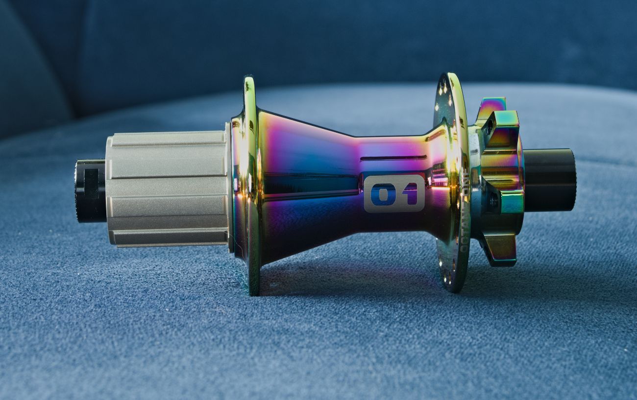 A bike freehub sits on a blue cloth surface.