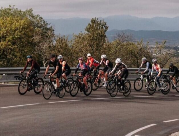 A large group of cyclists during a training ride around Girona.