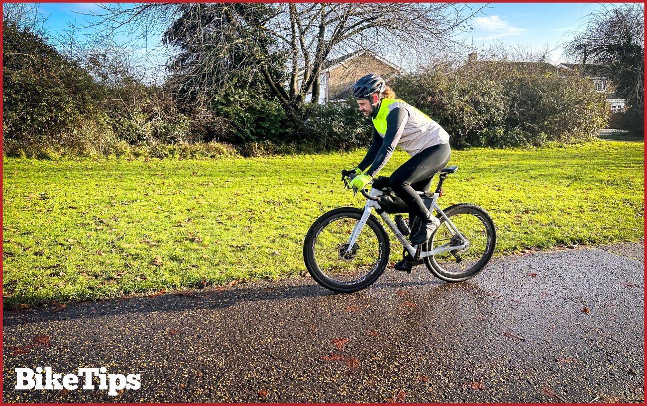 A cyclist riding in winter cycling gear.