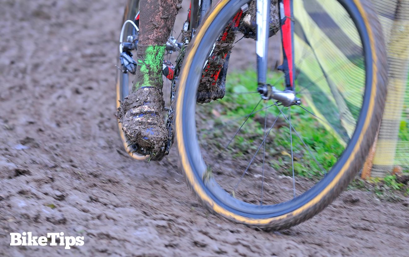 Close-up of a cyclocross racer demonstrating how to corner through mud.