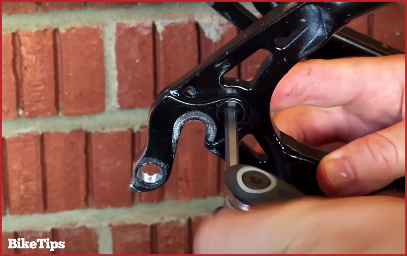 Removing the bent derailleur hanger.