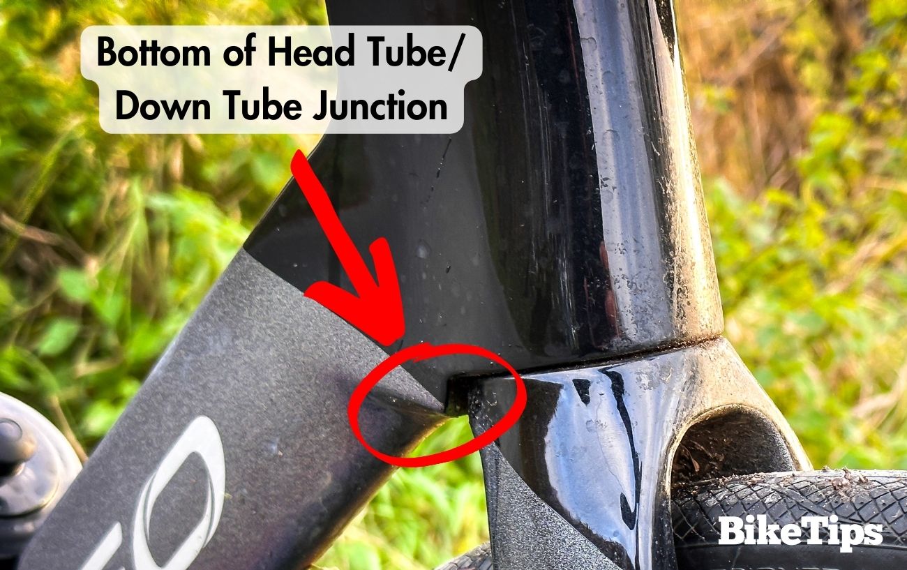Photo with annotations showing the location of the head tube/down tube junction.