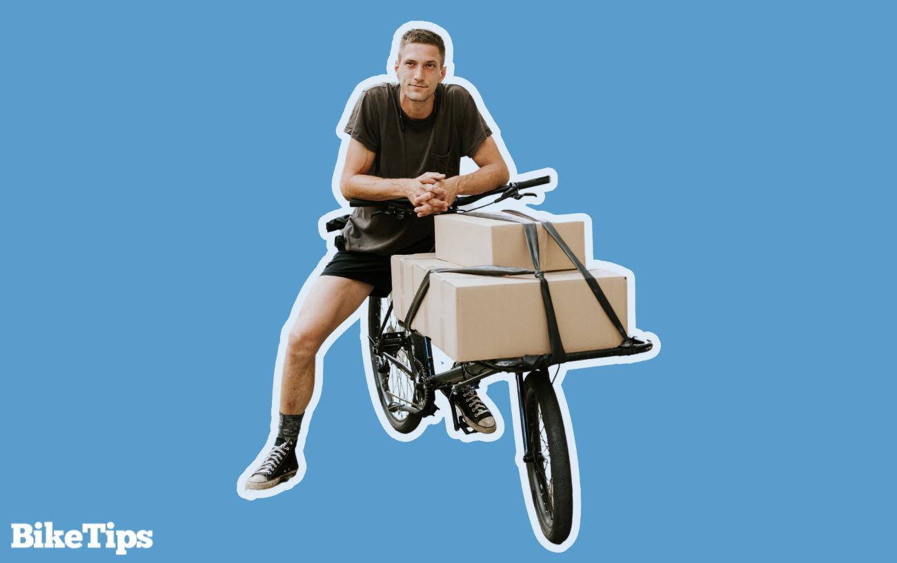 A man on a cargo bike, which often have higher eBike weight limits than other bikes.