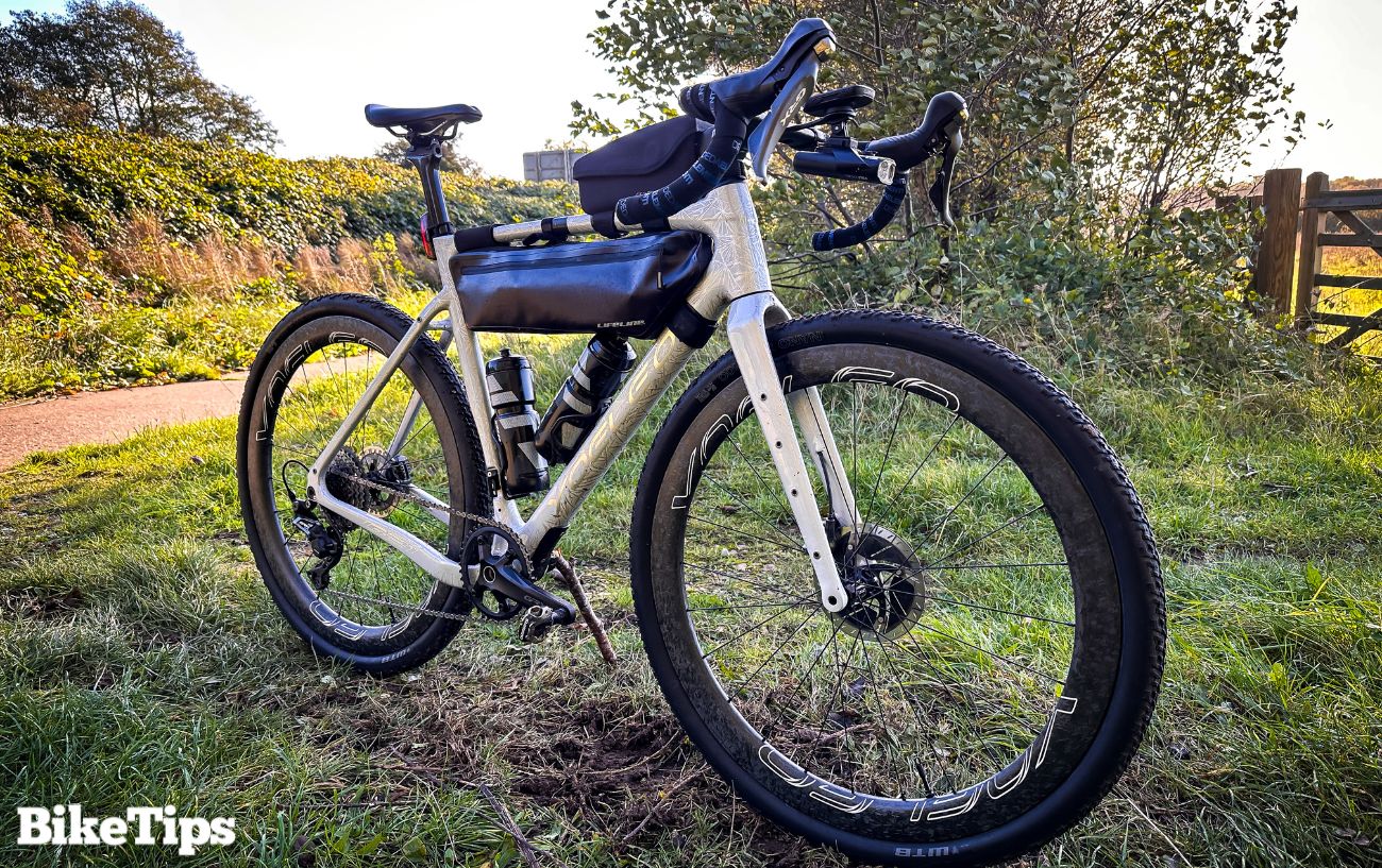 A white gravel bike on a muddy track.