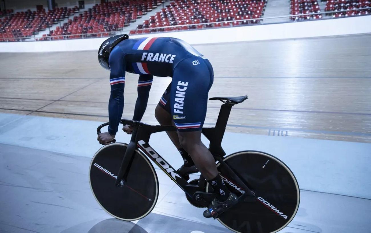 French cyclist riding a Look T20 track bike at a velodrome.
