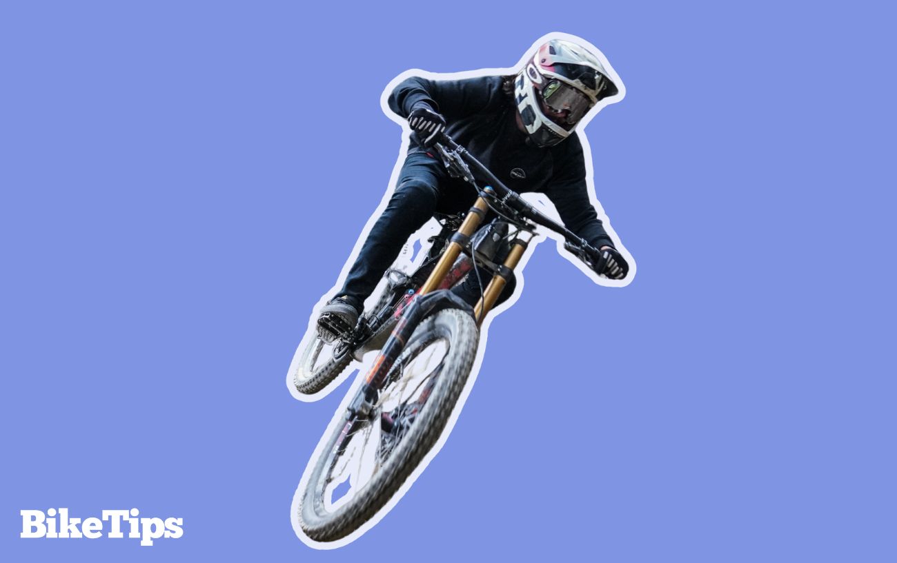 A mountain biker flies over a jump.