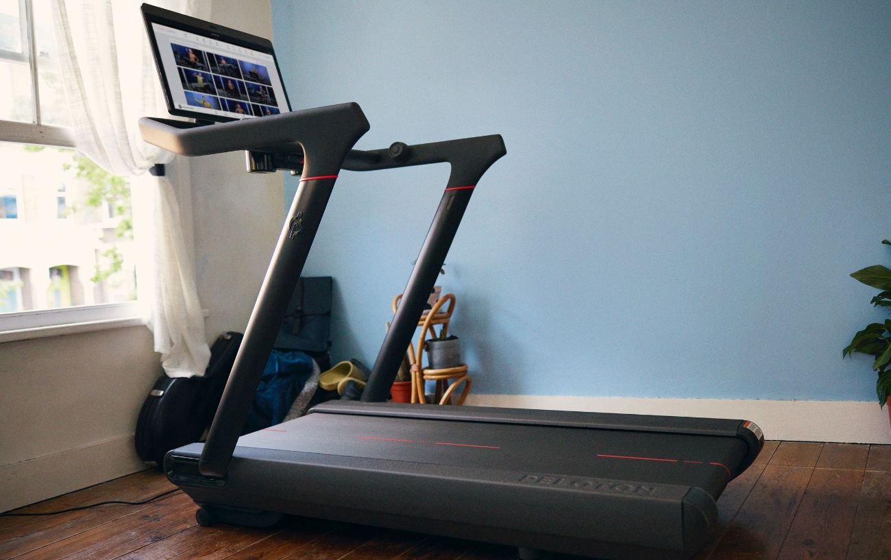 Peloton Tread in a room with a blue wall.