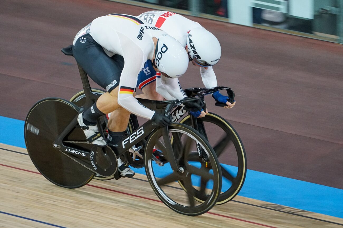 A British cyclist races a German cyclist on track bikes at the UCI World Championships.