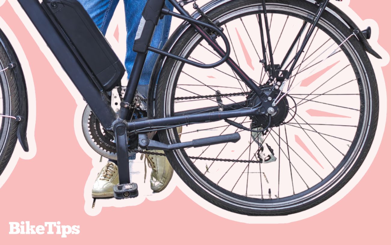 A hub-driven electric bike on a pink background.