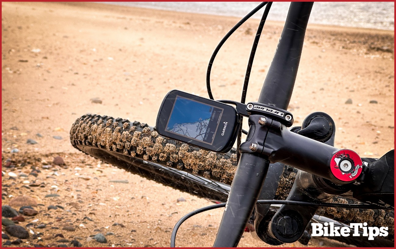 A Garmin on a mountain bike on the beach.
