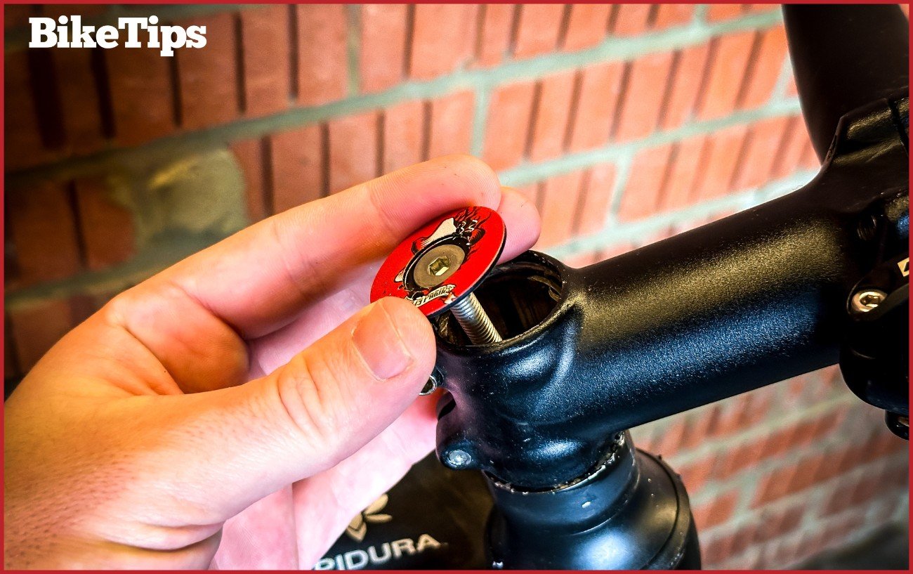A top cap being inserted into a bike.