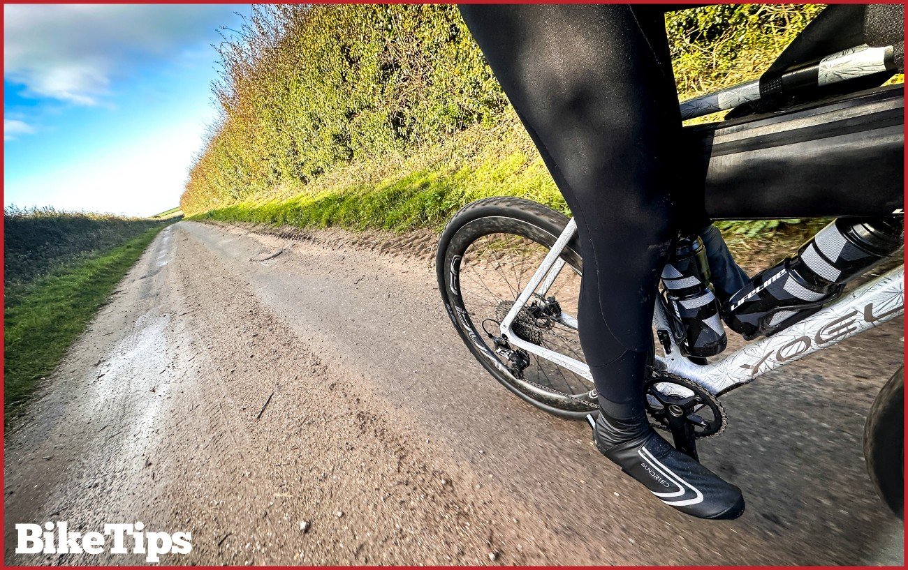 A gravel bike riding on a dusty road.