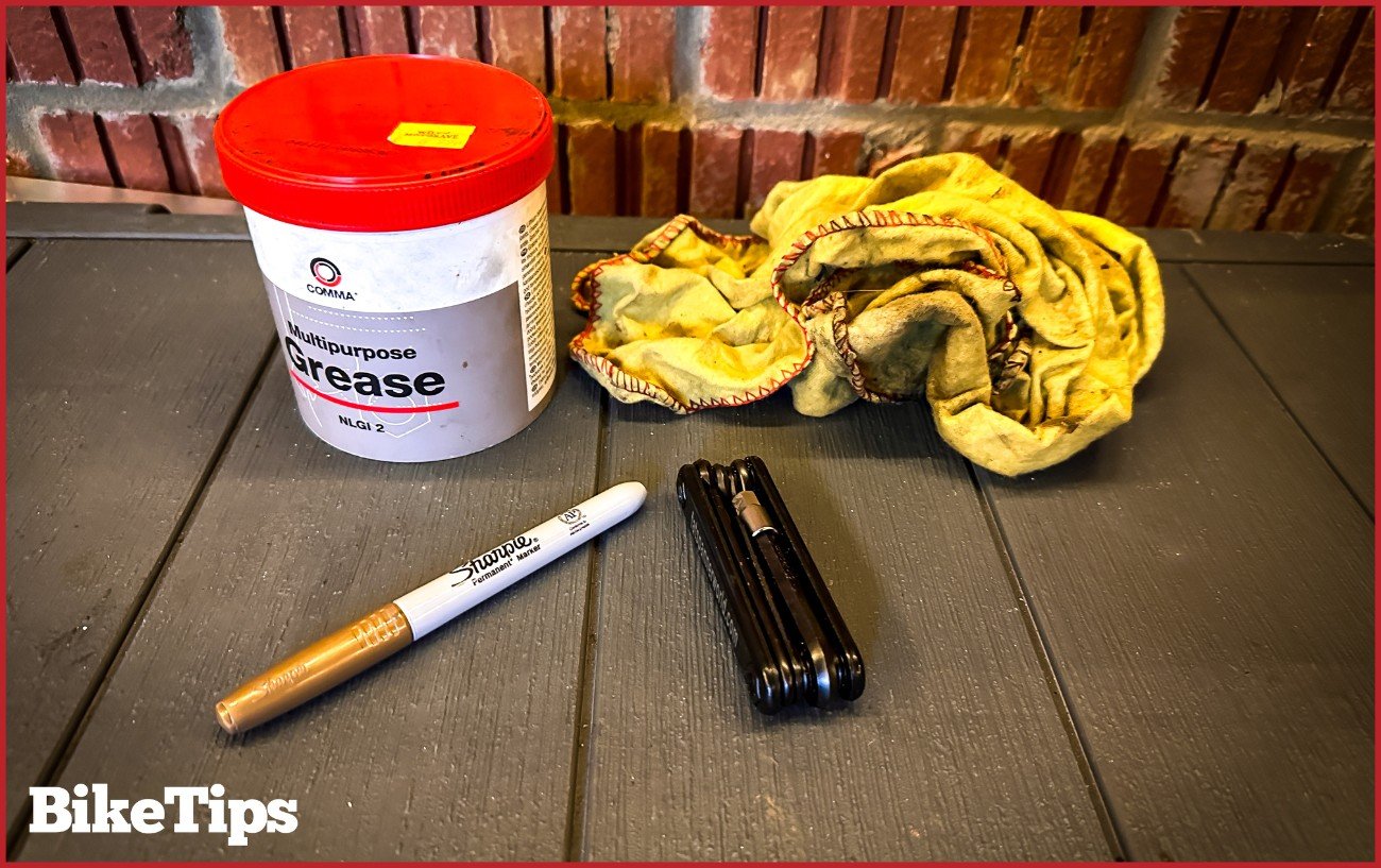 A pot of grease, a rag, marker pen, and a Allen key for adjusting cleats. 